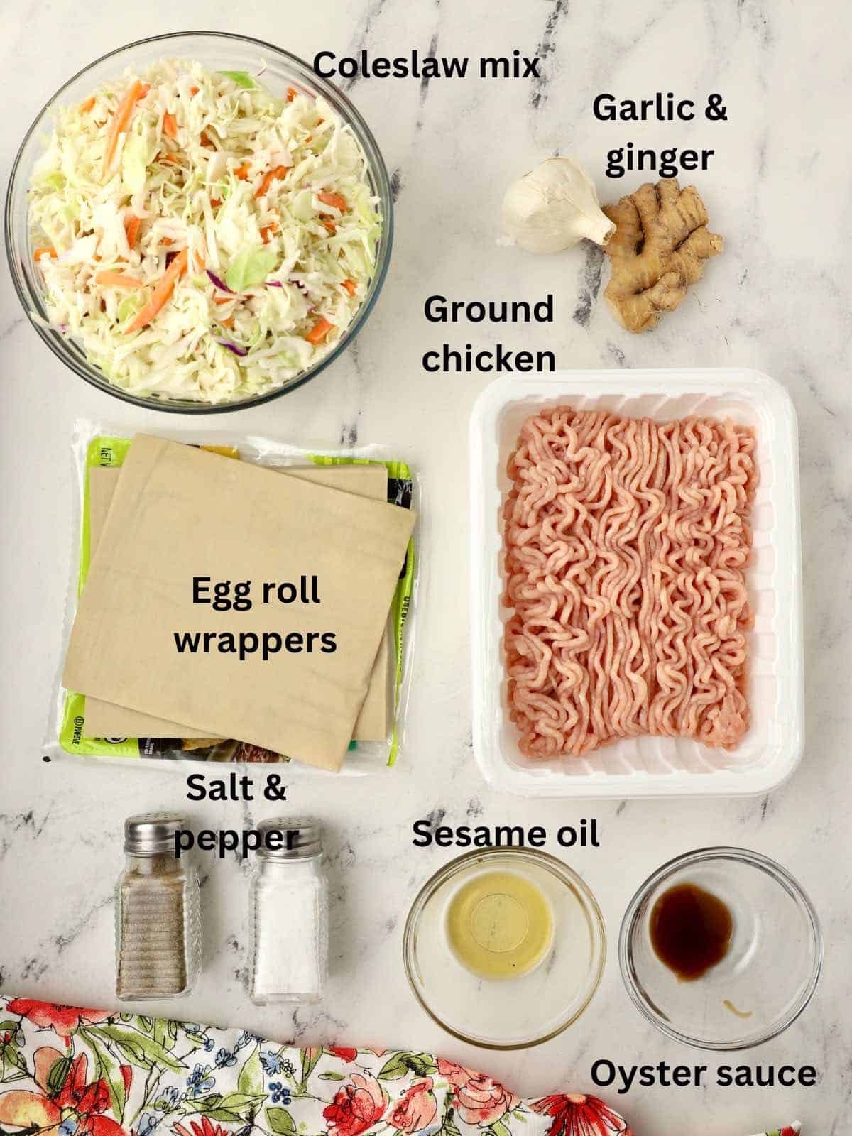 Ground raw chicken, wrappers, and coleslaw mix to make egg rolls.