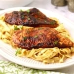 Blackened Chicken Alfredo on a bed of fettuccine.
