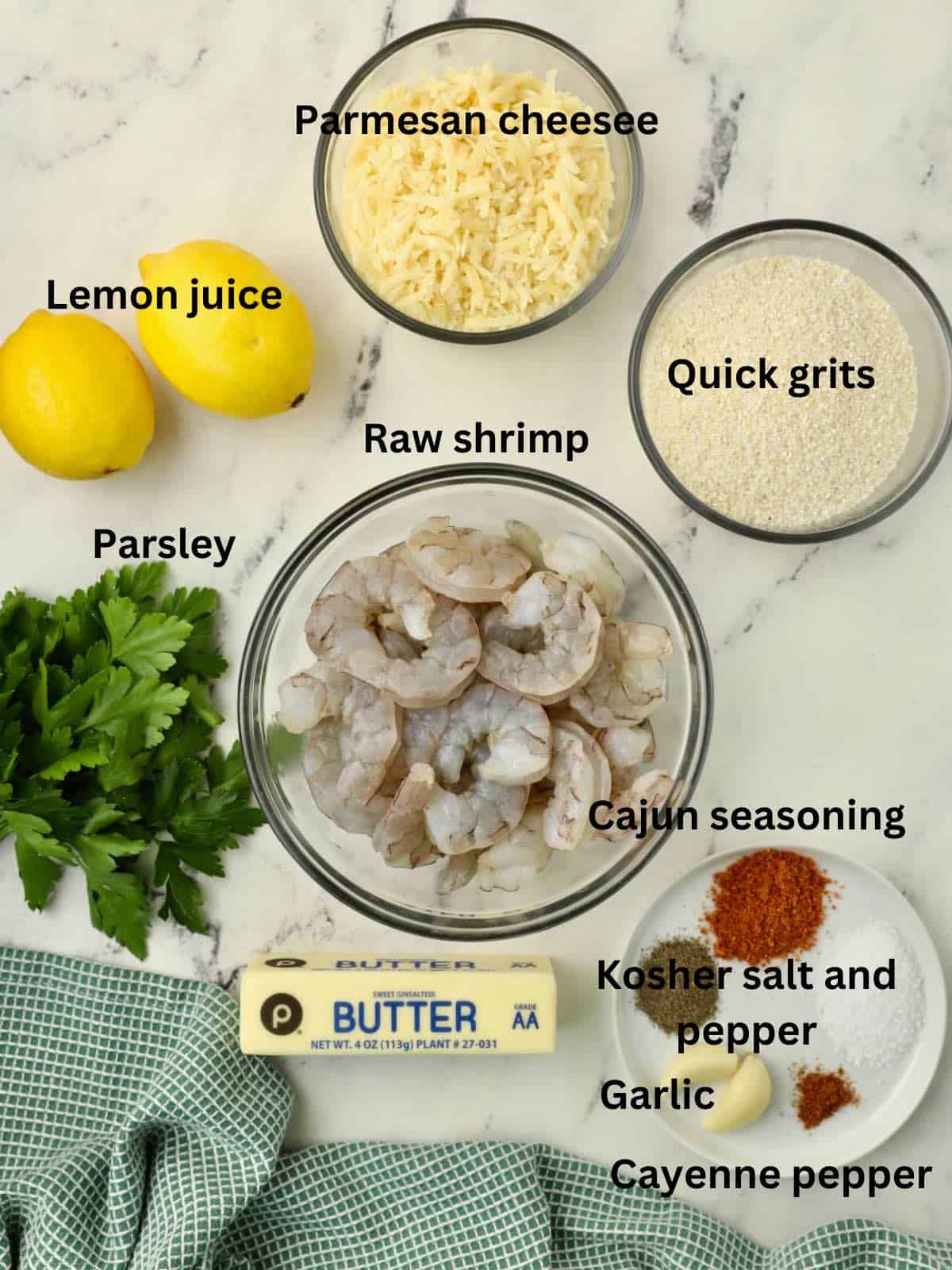 Ingredients for shrimp and grits, including raw shrimp and shredded cheese. 