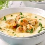 Pinterest pin showing a bowl of shrimp and grits garnished with parsley.