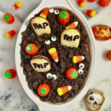 Halloween Graveyard Chocolate Cheesecake Dip topped with Halloween candy.