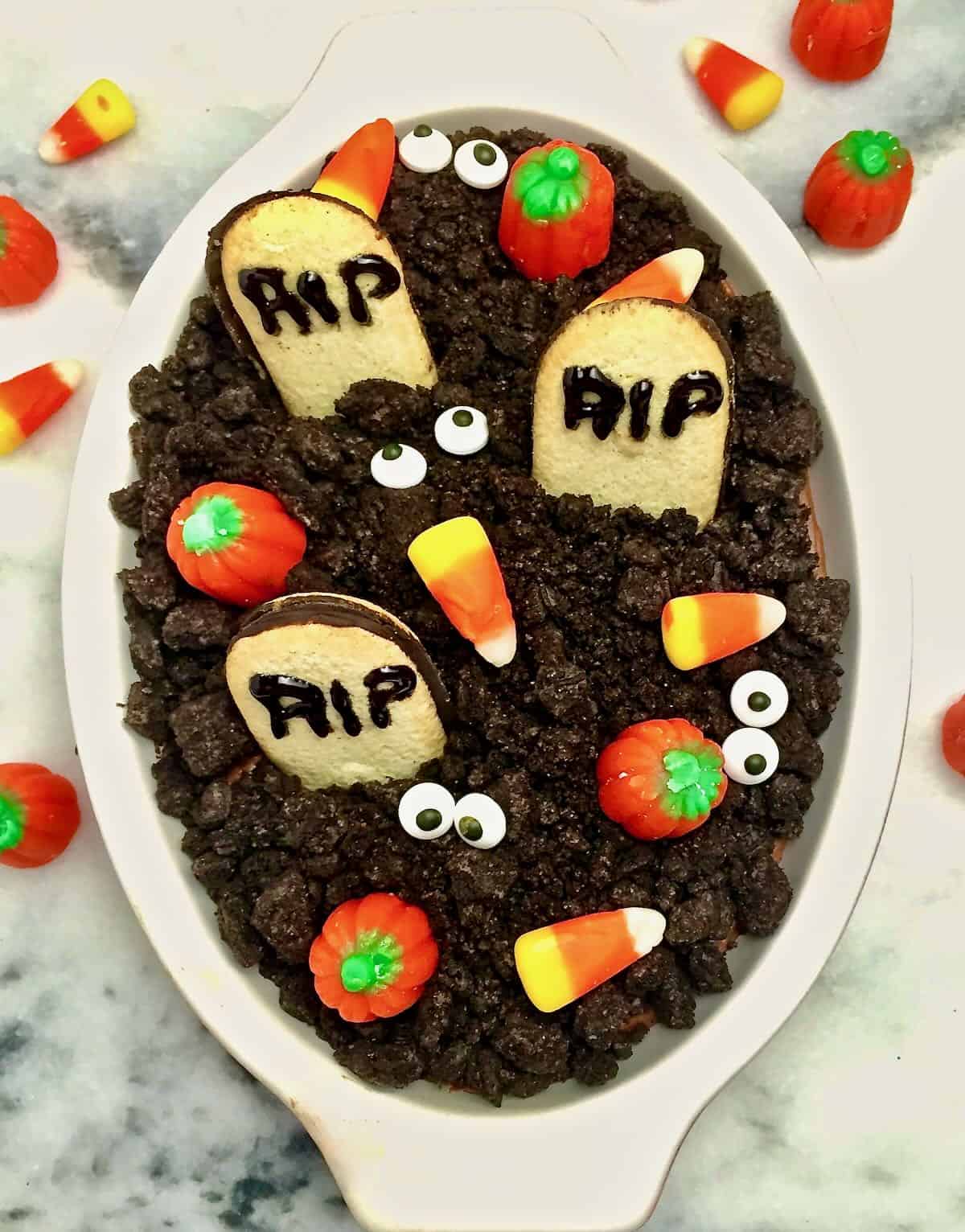 Chocolate Graveyard Cheesecake dip topped with cookie tombstones. 