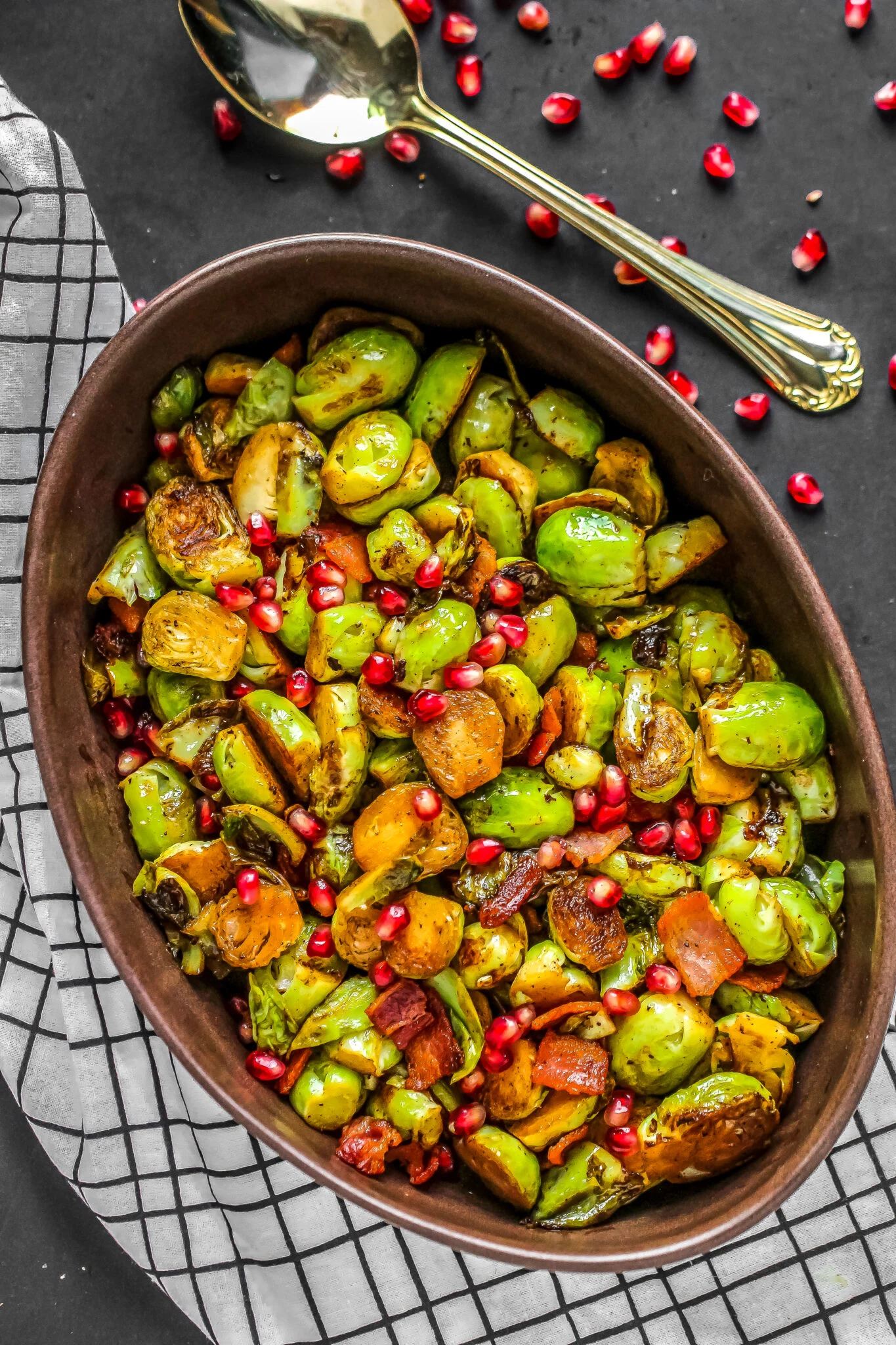 Brussels sprouts in a large bronze metal serving dish. 