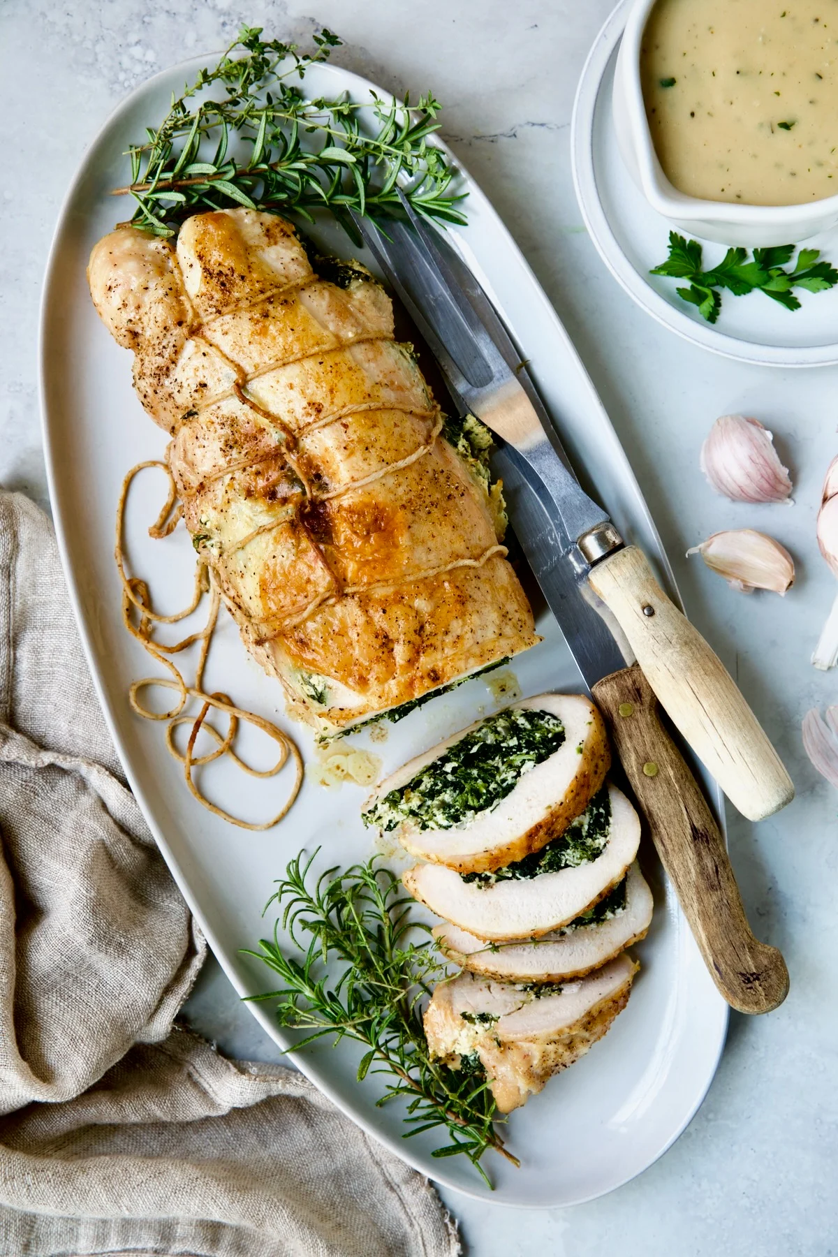 Stuffed turkey breast with slices cut showing the spinach and ricotta stuffing. 