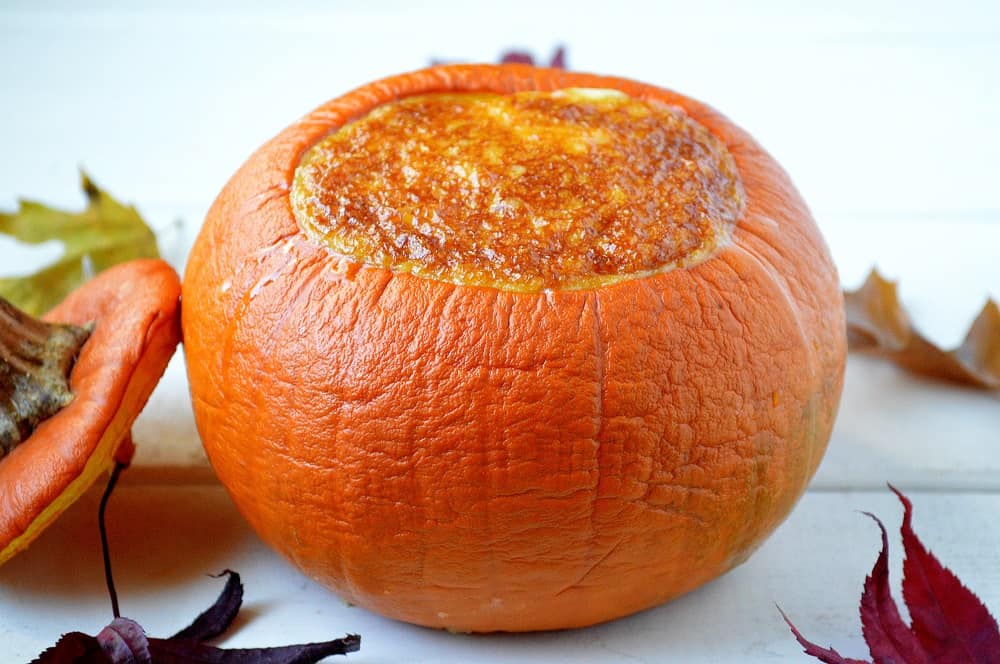 A pumpkin hollowed out and filled with pumpkin pie filling. 