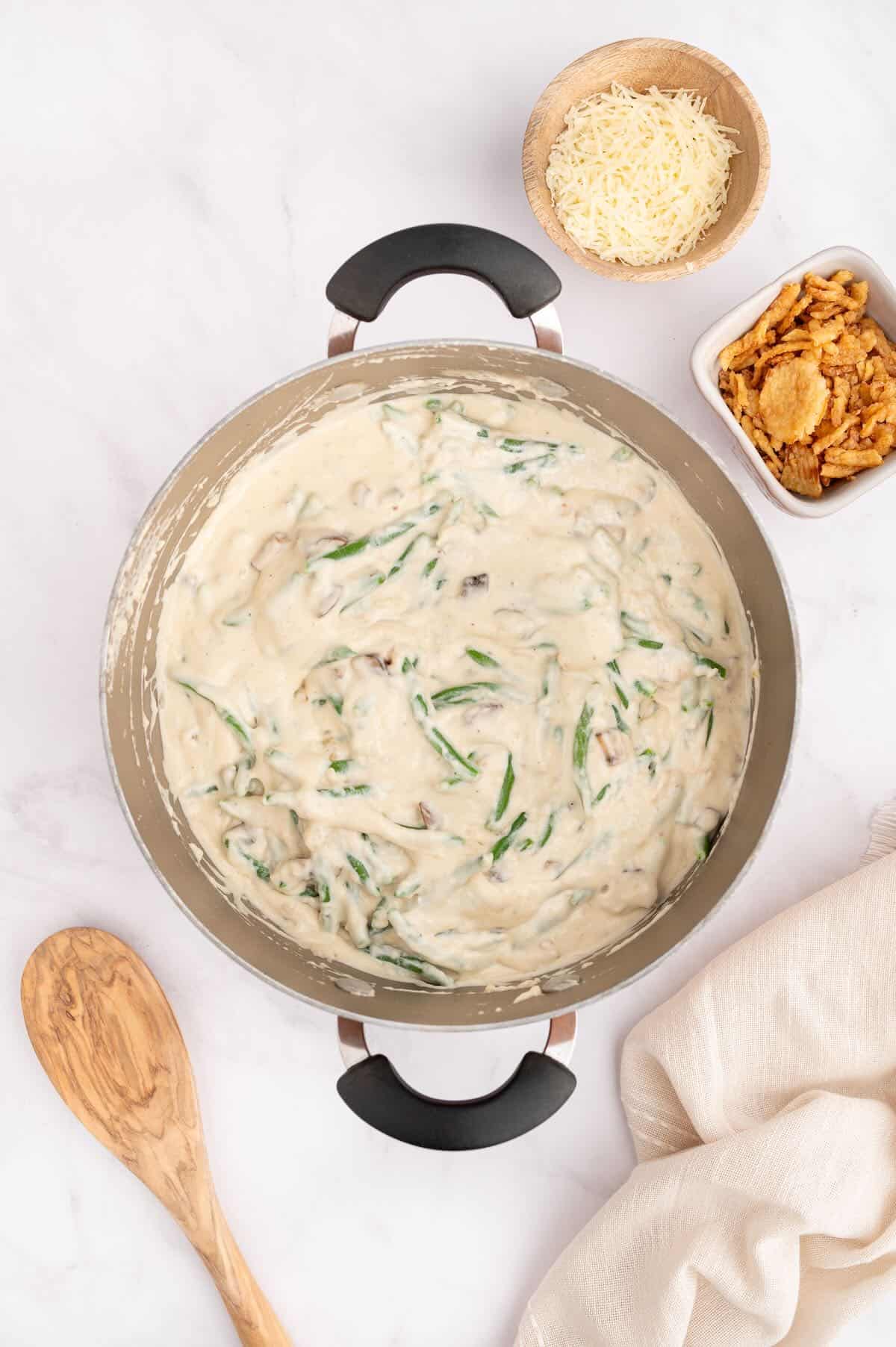 Green beans are cooked in a creamy soup mixture in a skillet. 