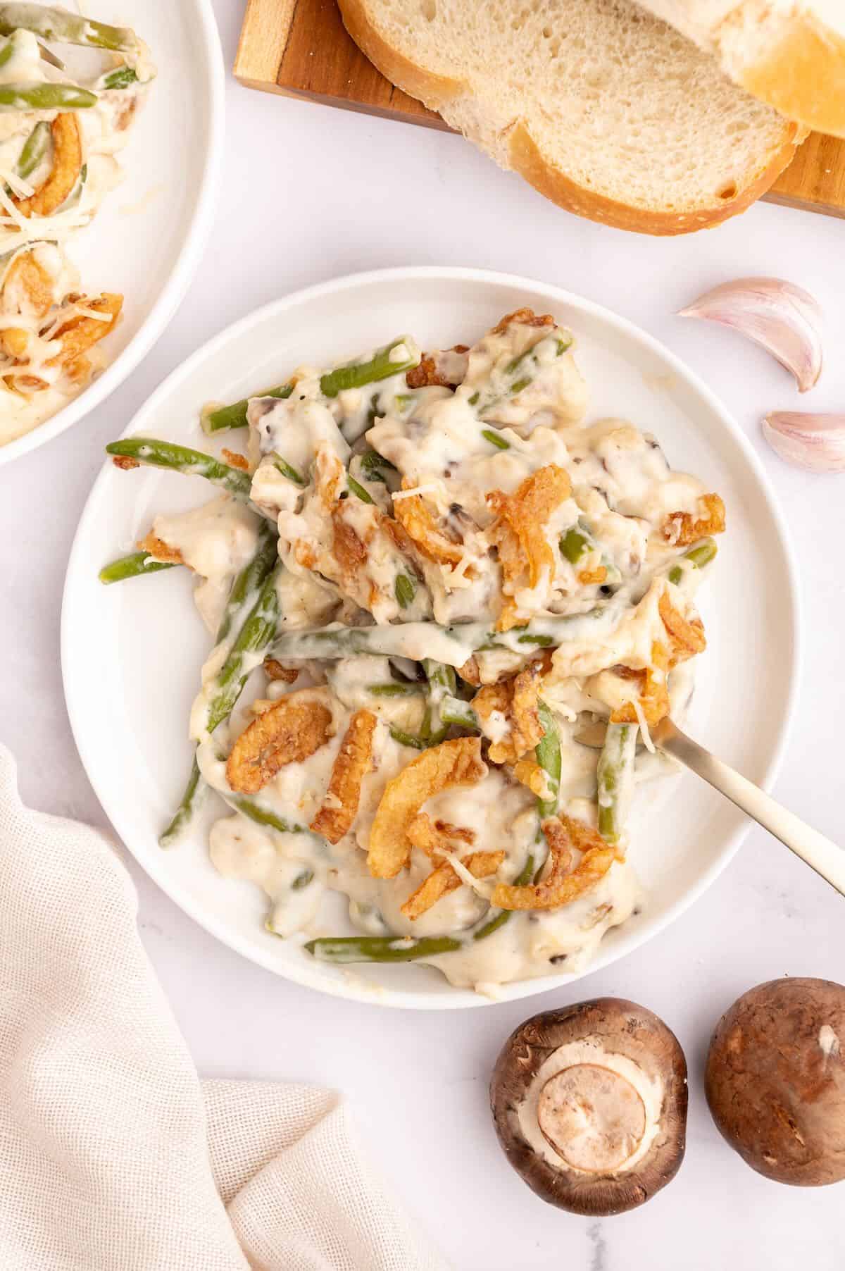 A serving of green bean casserole on a white plate. 