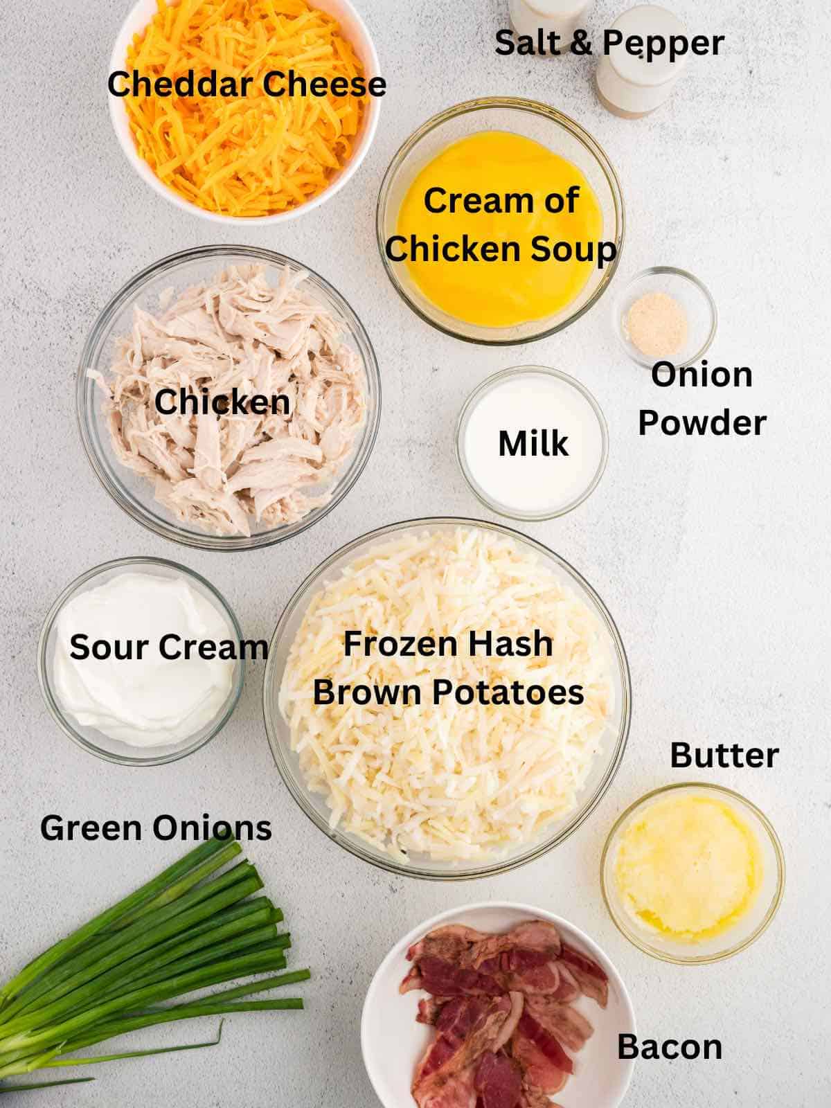 Ingredients for a hash brown casserole including cooked chicken and frozen hash browns. 