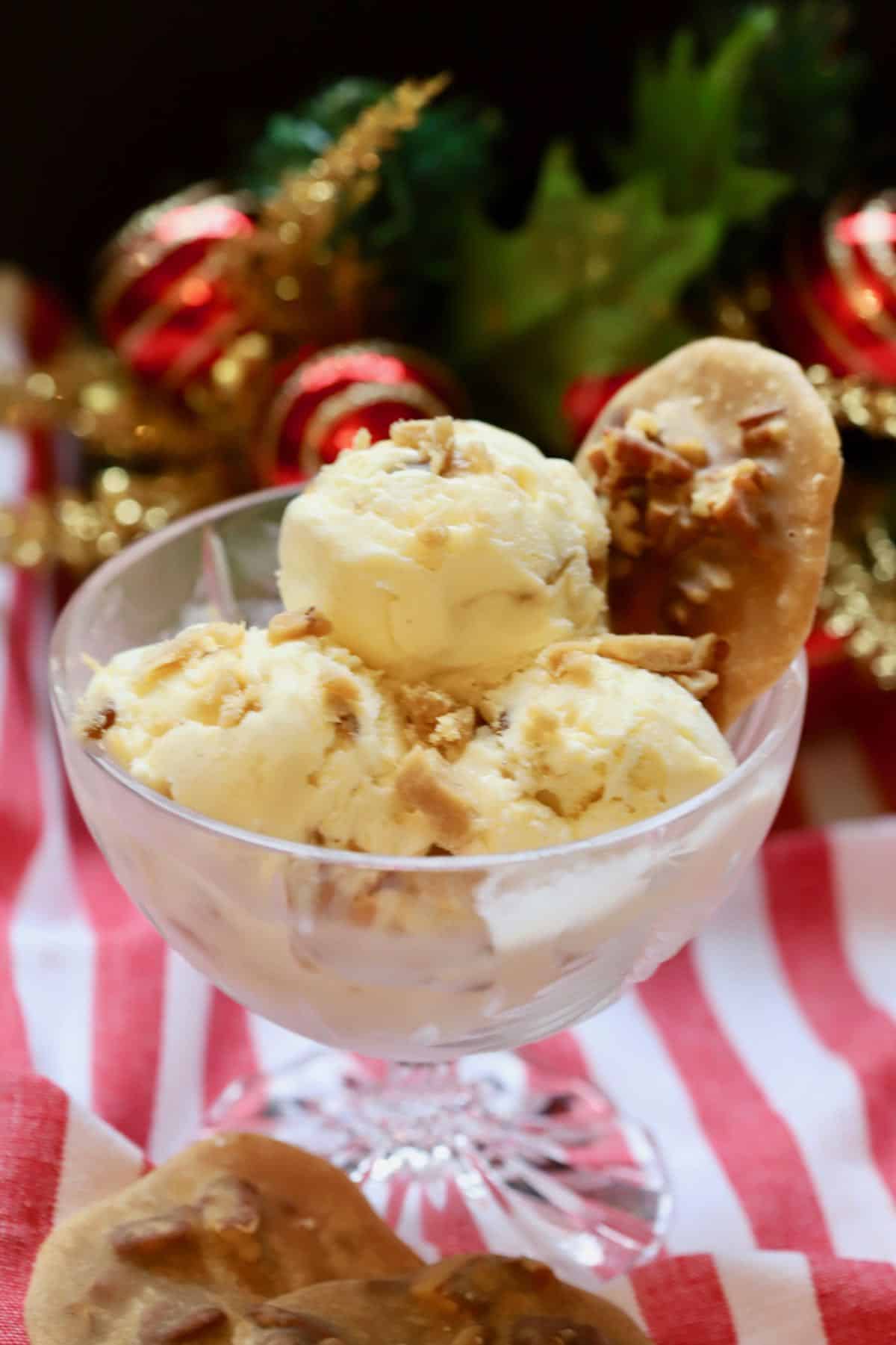 Three scoops of pecan pralines ice cream in a cut glass dish. 