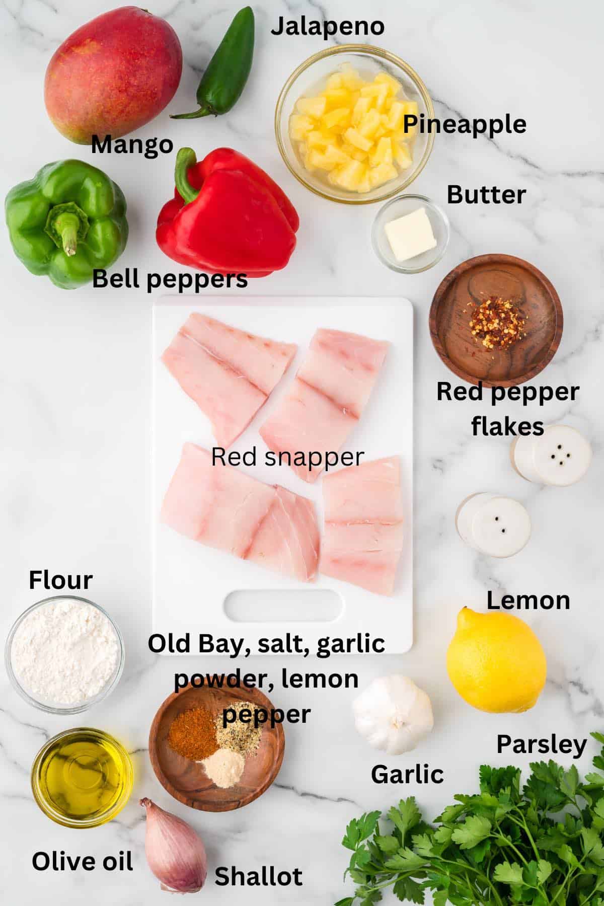Ingredients for pan-seared snapper including fish fillets, a mango, and bell peppers. 