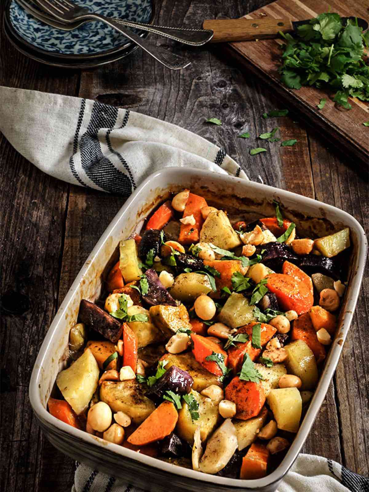 A baking dish full of roasted root vegetables including carrots. 