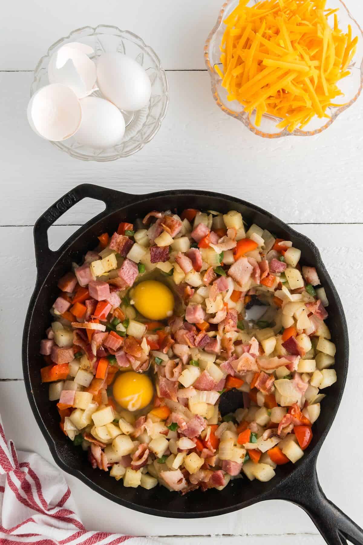 Breakfast skillet with wells created in the vegetables to add eggs. 