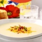 The pin shows a white bowl of potato soup topped with cheese, bacon, and chives.