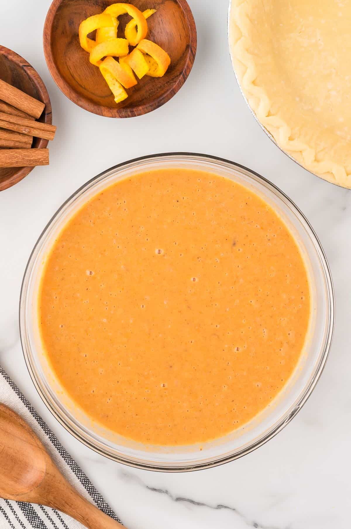 Sweet potato pie filling in a clear glass bowl. 