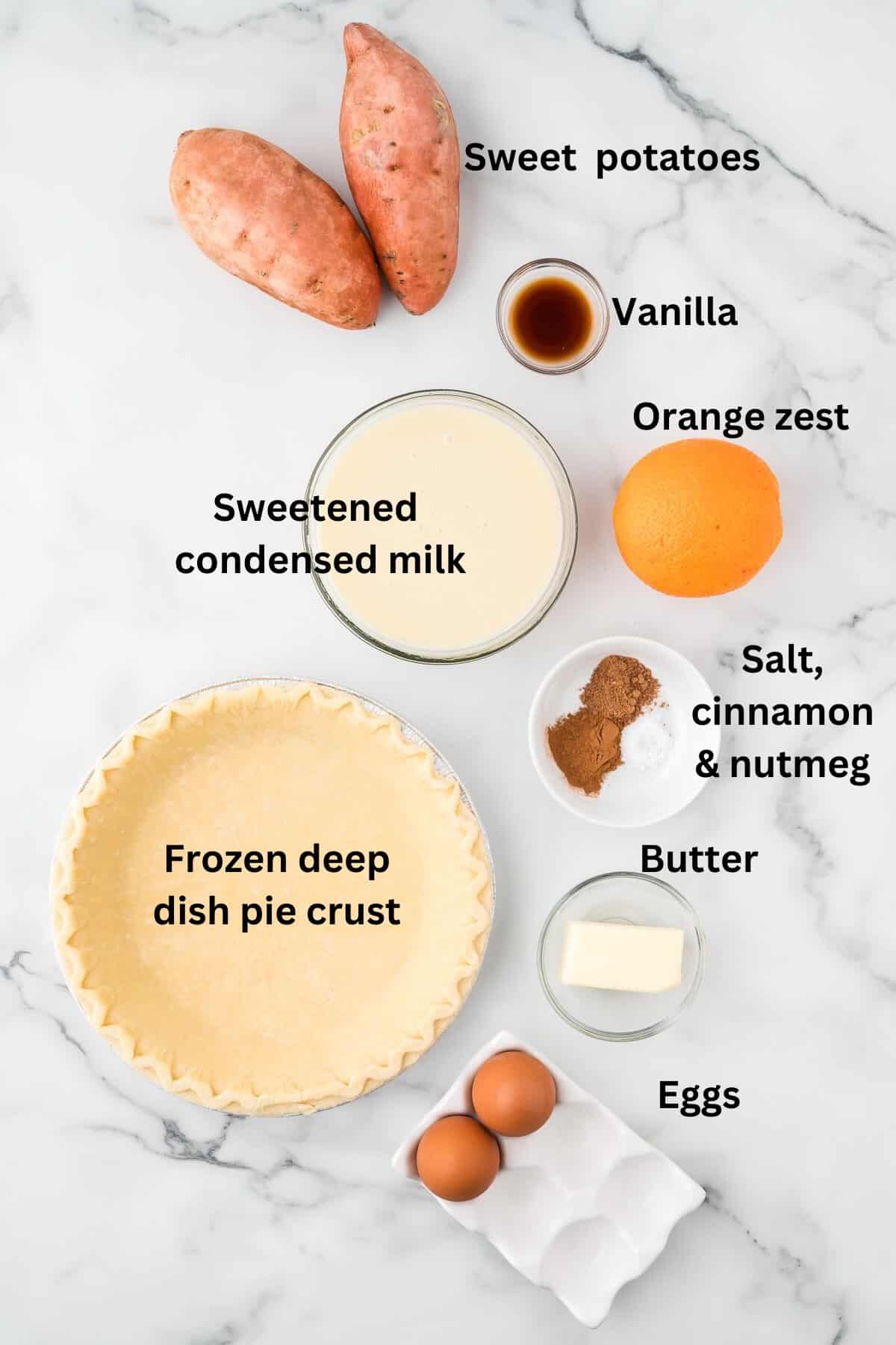 Ingredients for sweet potato pie including sweet potatoes and a pie crust. 
