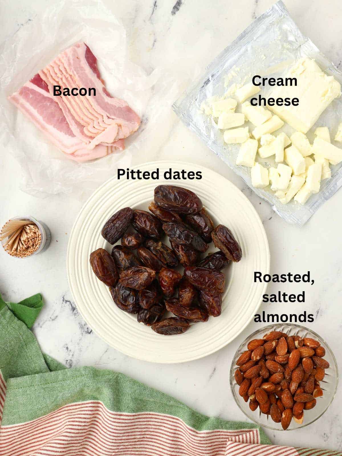 A plate of dates, raw bacon slices, half a block of cream cheese, and a bowl of almonds. 
