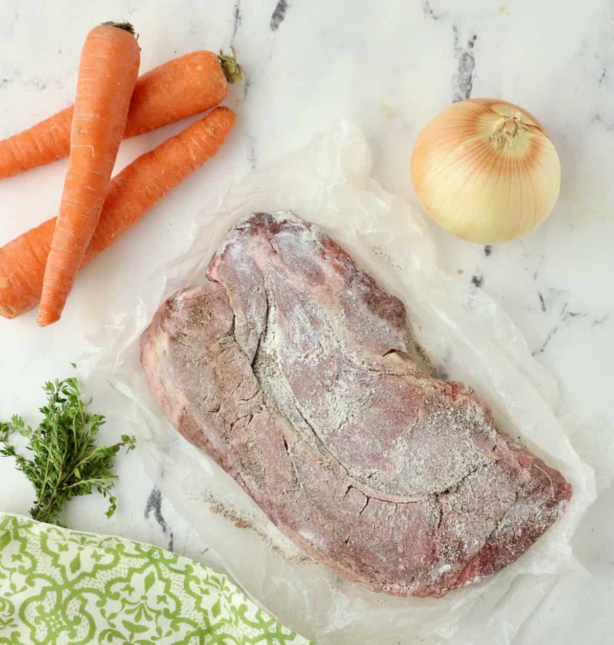 A chuck roast that has been seasoned with salt and pepper and dusted with flour before cooking. 