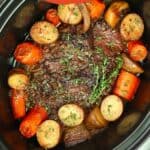 Pinterest pin showing a pot roast in a crock pot with potatoes and carrots.