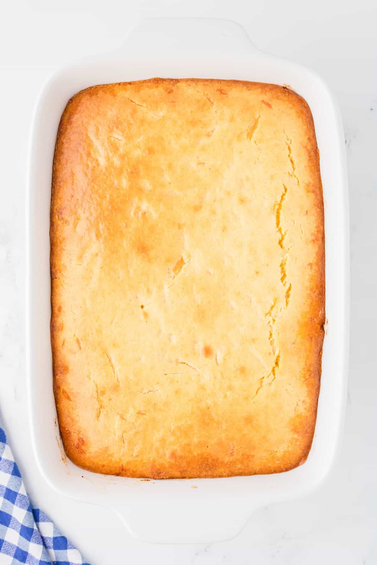 Baked sloppy joe cornbread casserole in a white baking dish. 