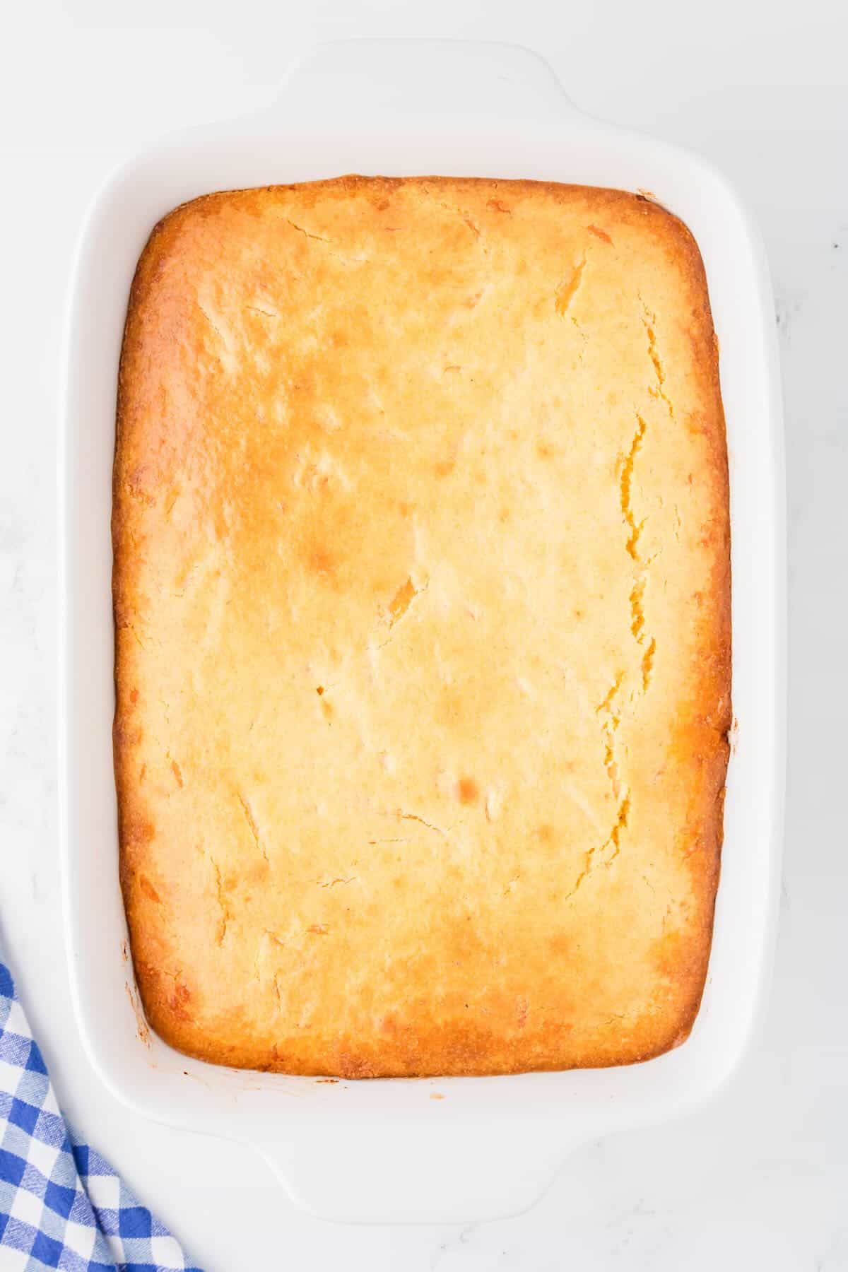 Baked sloppy joe cornbread casserole in a white baking dish. 