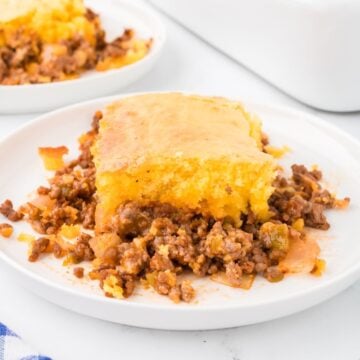 A slice of sloppy joe cornbread casserole on a white plate.