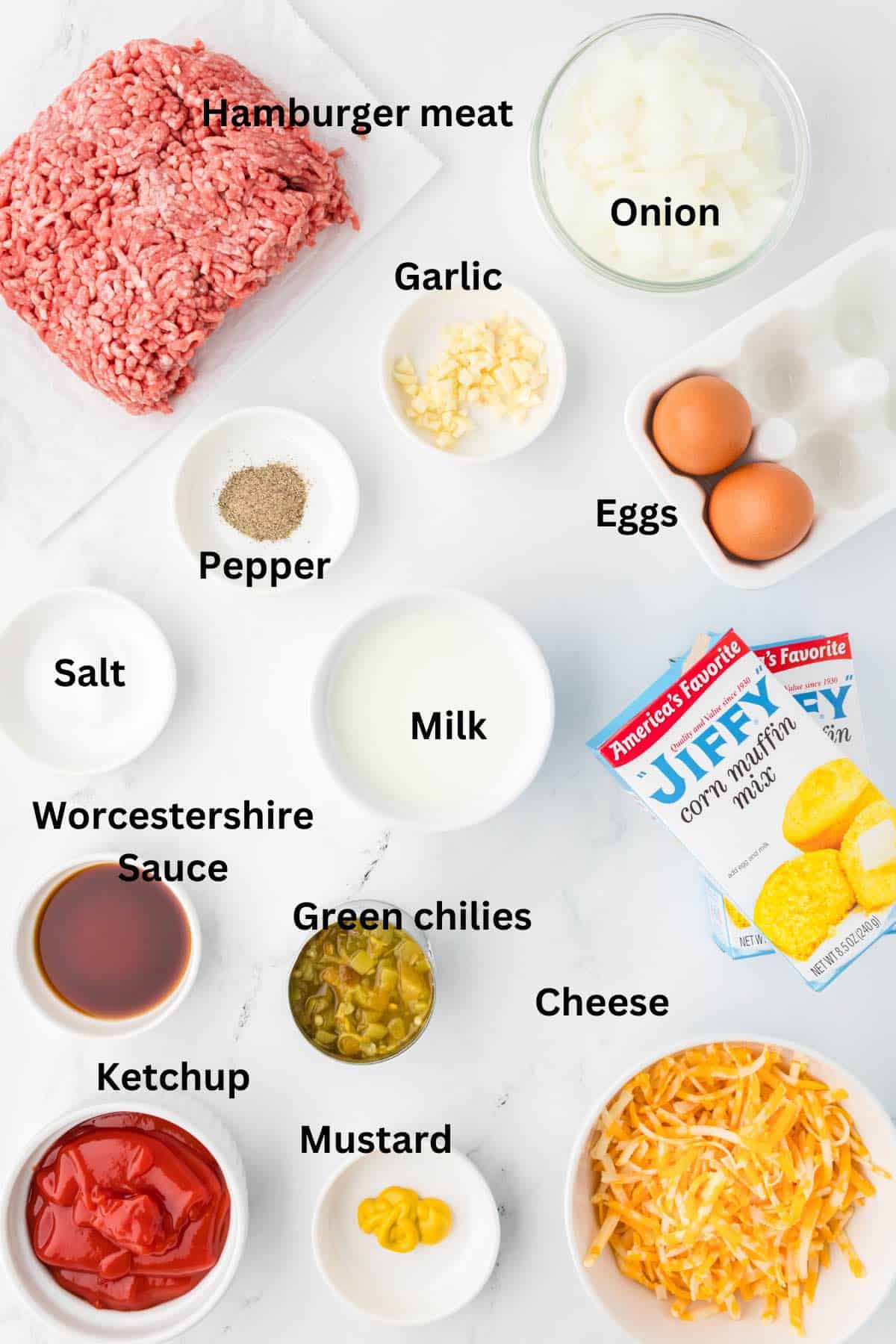 Ingredients to make sloppy joe cornbread casserole including hamburger meat and cornbread mix. 