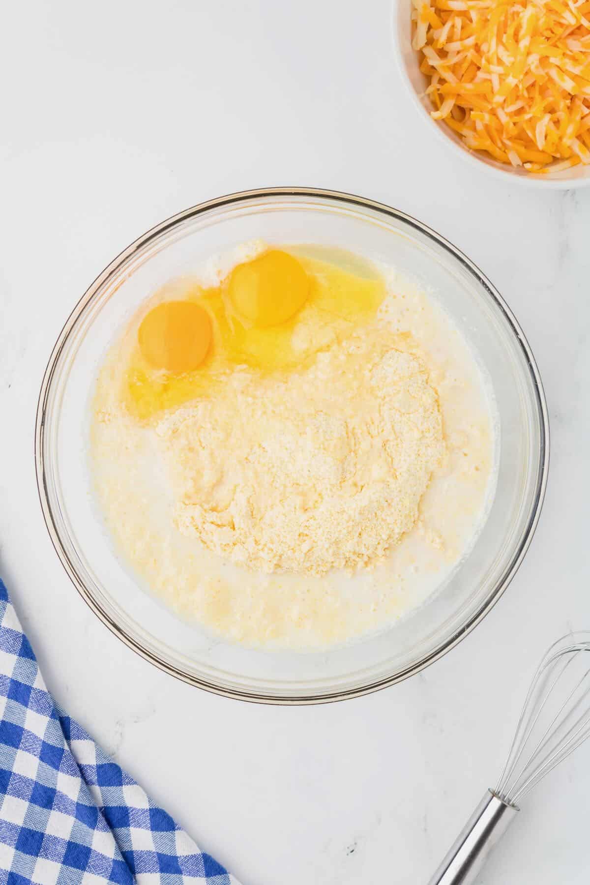 Jiffy corn muffin mix, eggs, and milk in a bowl. 