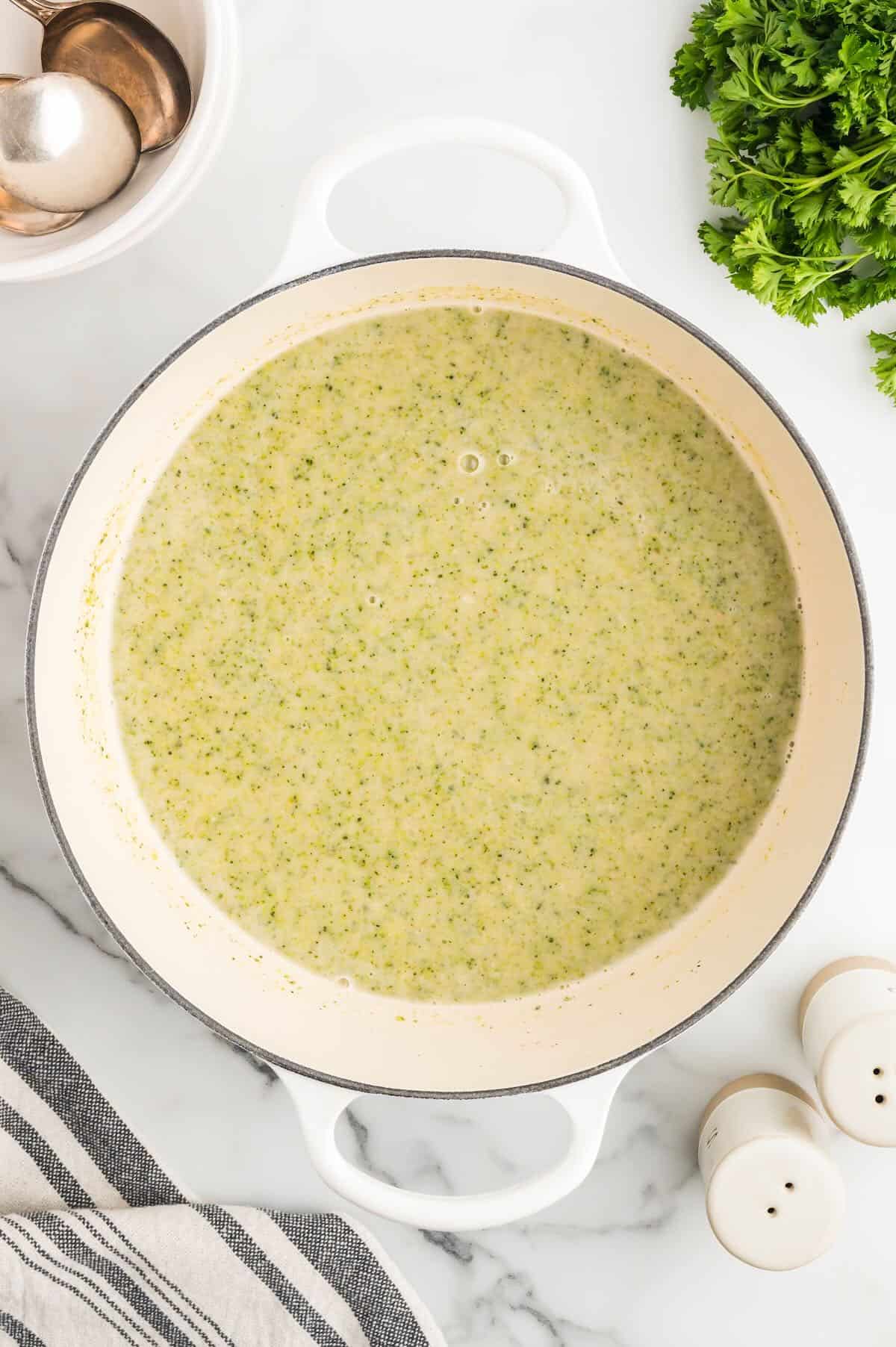 Pureed broccoli white bean soup in a white stock pot. 
