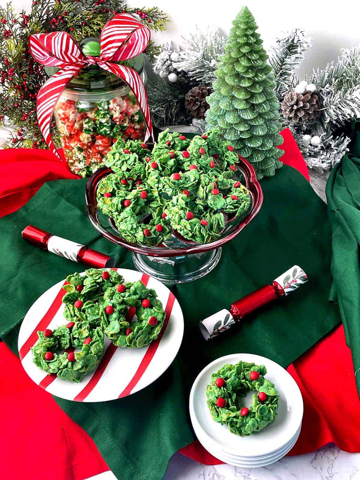 A red and white striped plate with a stack of Green Christmas Cornflake Wreaths Candy. 