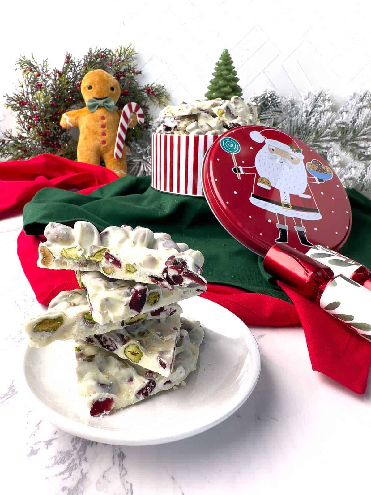 Christmas decorations and a plate of white chocolate holiday bark. 