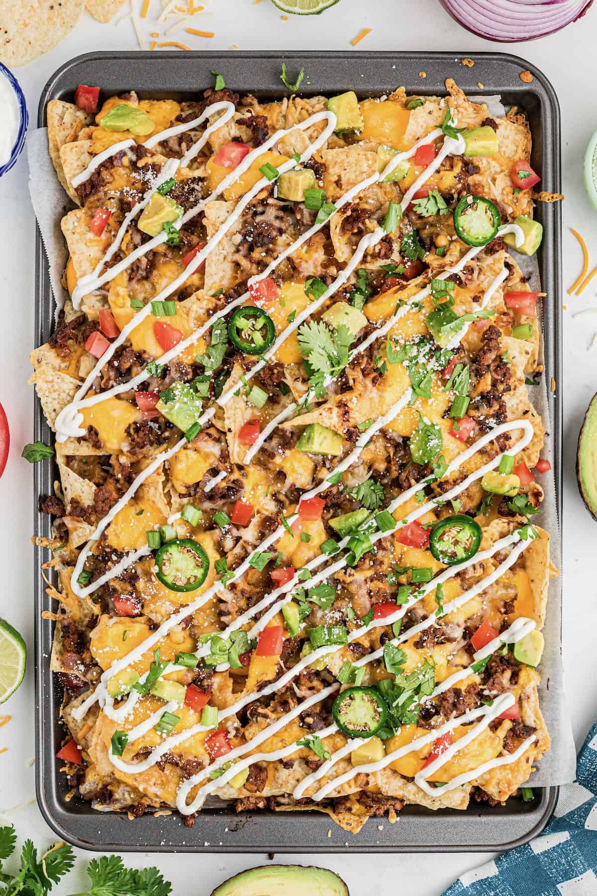 Ultimate loaded ground beef nachos topped with sour cream. 