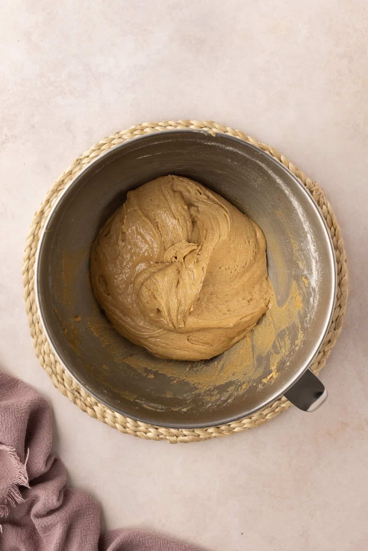 Cookie dough in a metal mixing bowl. 