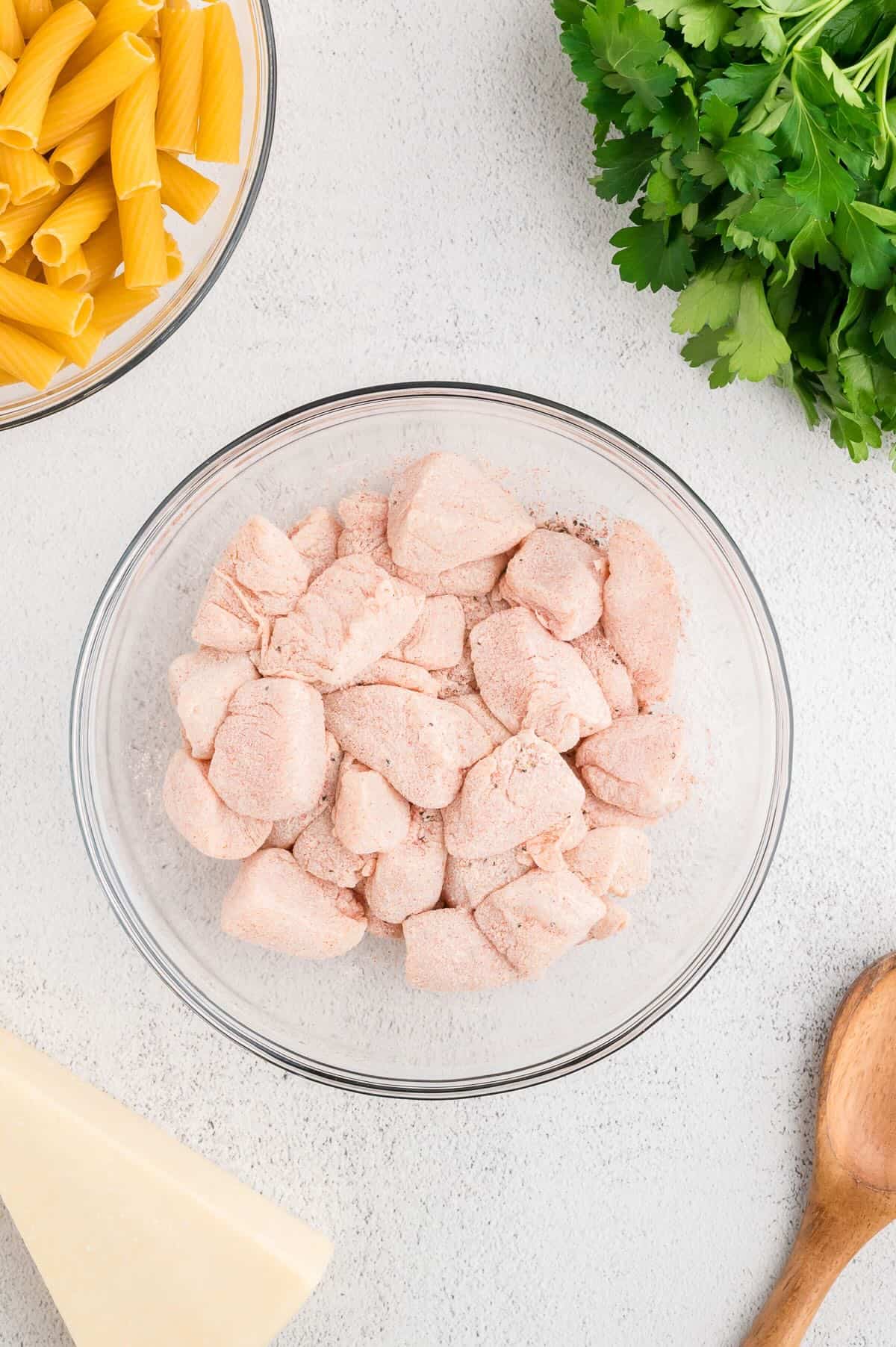 Cubes of raw chicken coated with flour and seasonings. 