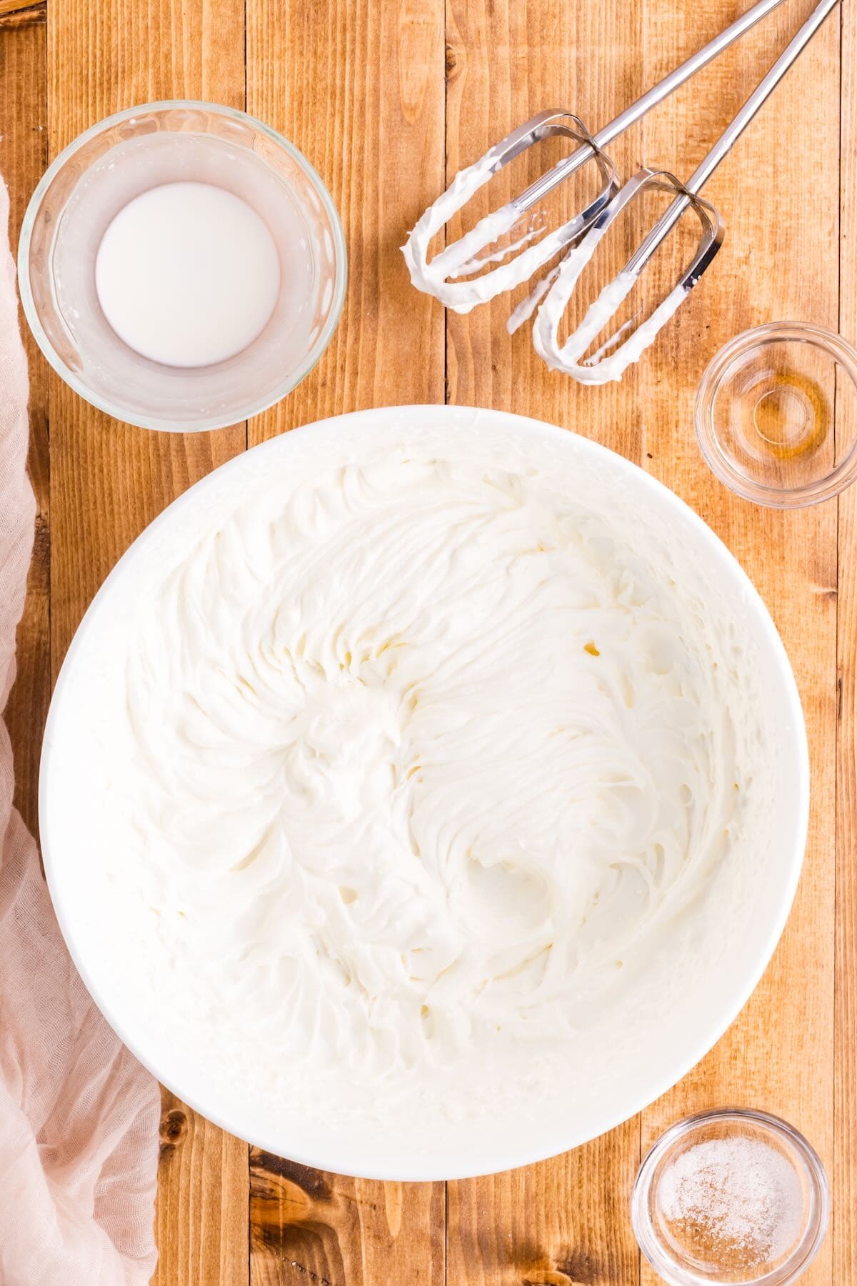 A bowl of whipped cream that has been whipped to stiff peaks. 
