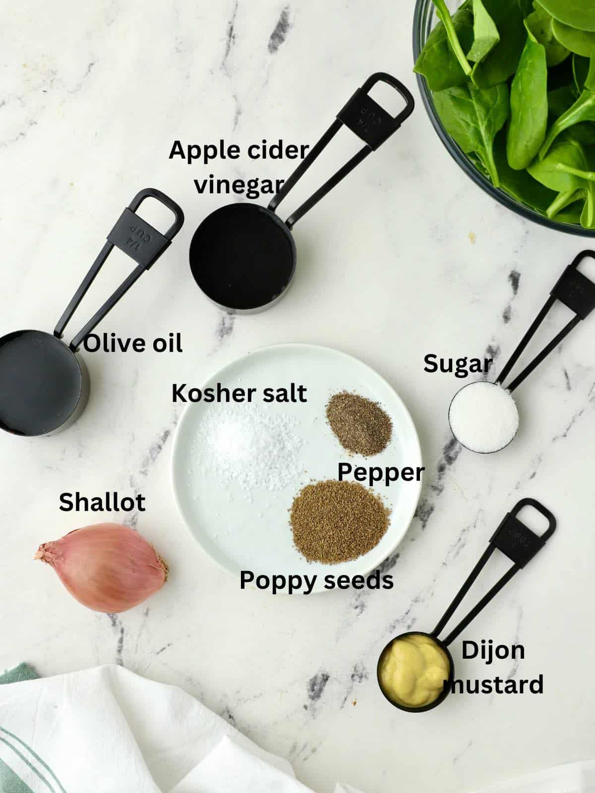 Poppyseed dressing ingredients including apple cider vinegar, olive oil, and Dijon mustard. 