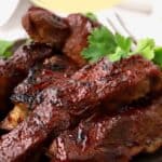 Pinterest pin showing cooked boneless pork ribs on a bronze plate.