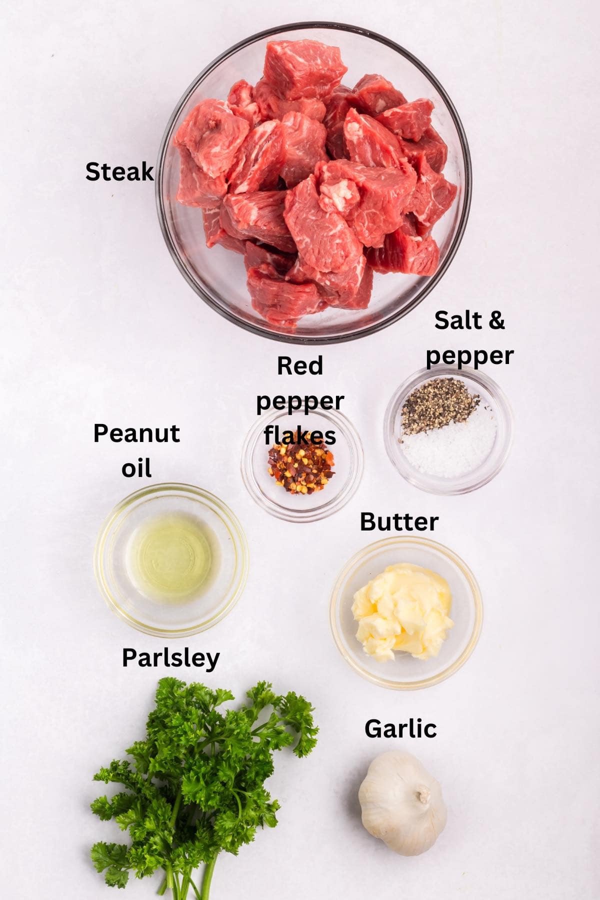 Ingredients for garlic butter steak bites include steak, butter, garlic, parsley and red pepper flakes. 