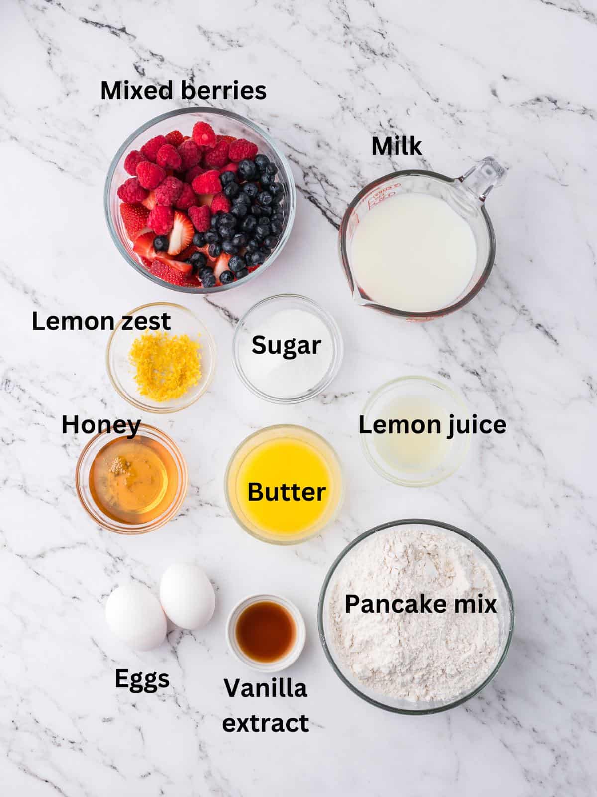 Ingredients for sheet pan pancakes including pancake mix, melted butter and eggs. 