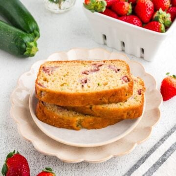 Slices of strawberry zucchini quick bread on a plate.