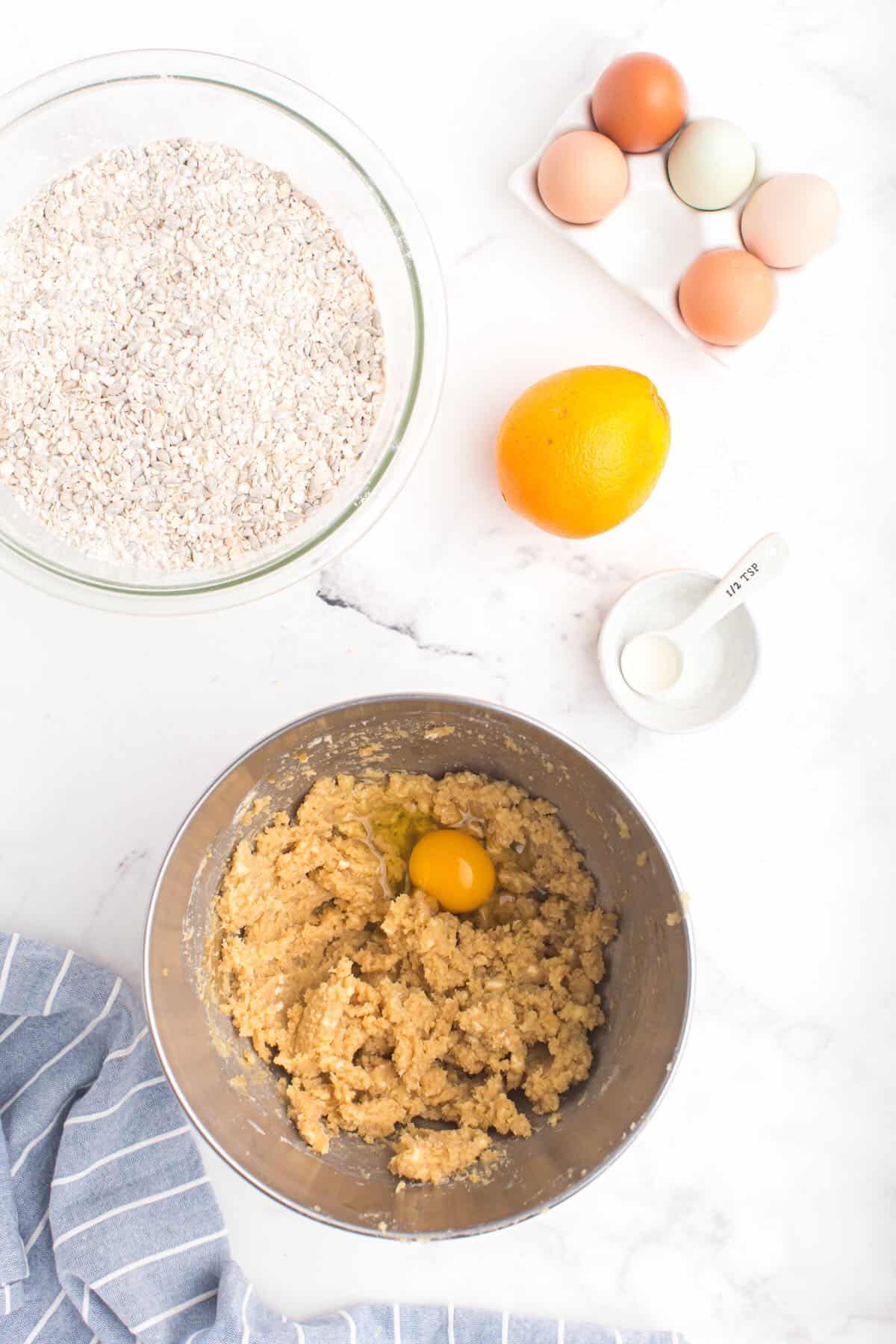 A metal bowl with brown sugar, melted butter and an egg. 