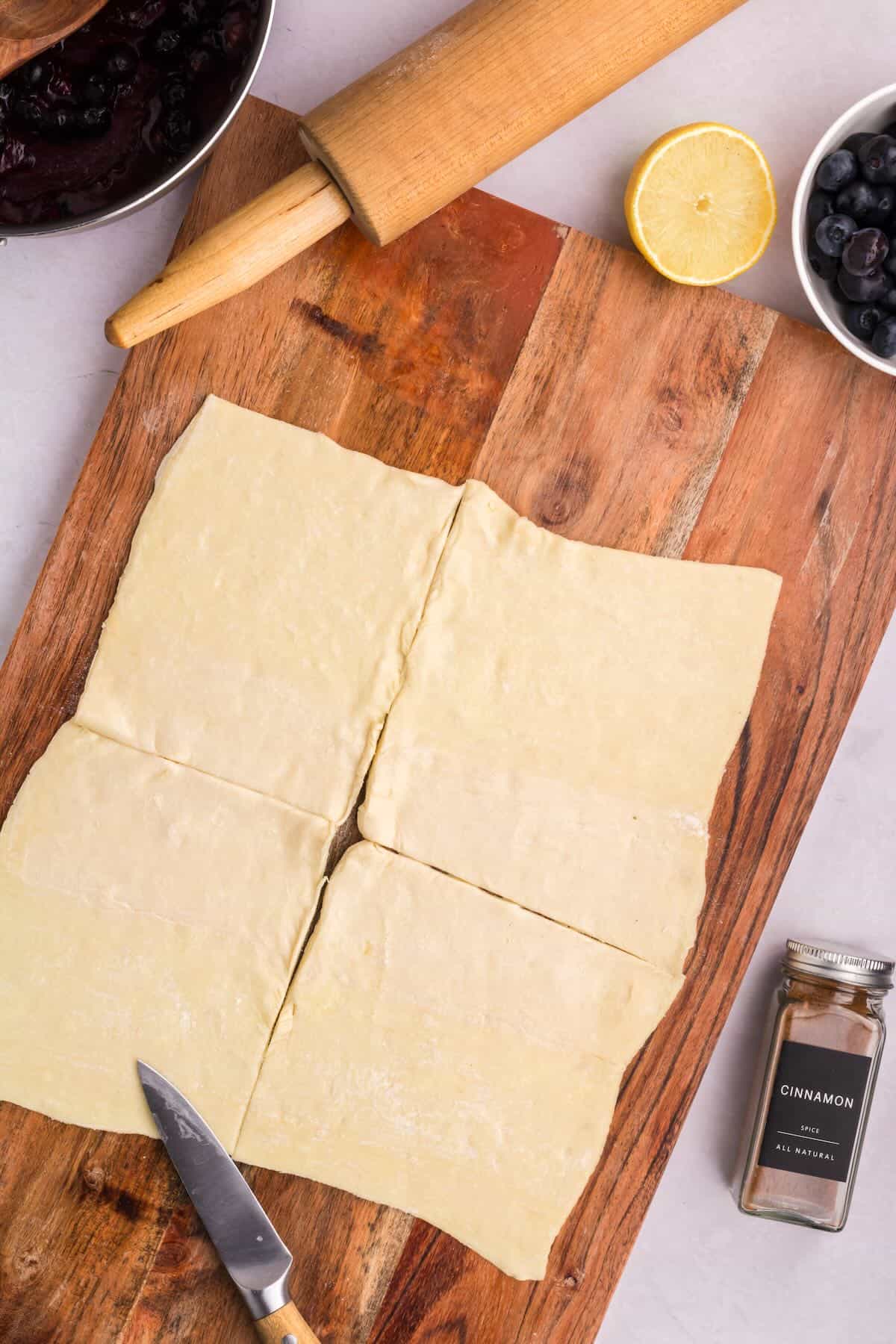 A piece of puff pastry is cut into four squares. 