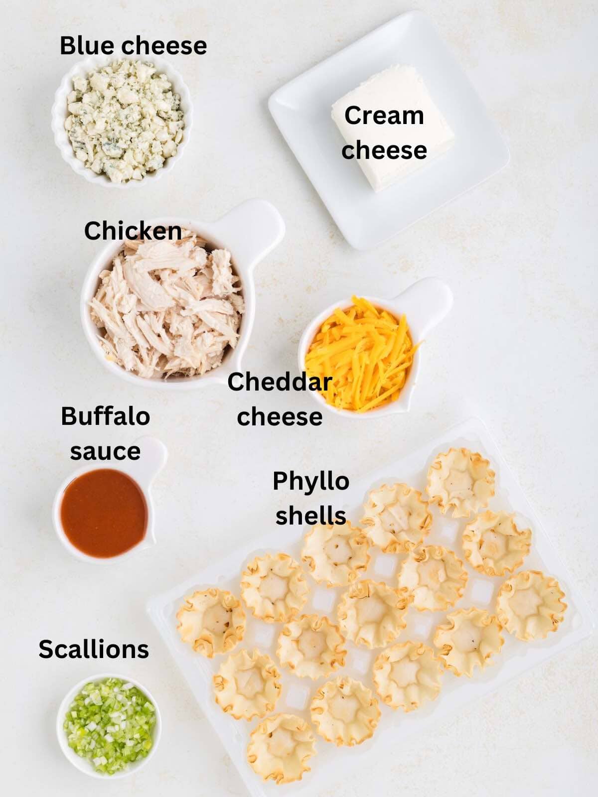 Ingredients for buffalo chicken bites include shredded chicken, buffalo sauce and cheese. 