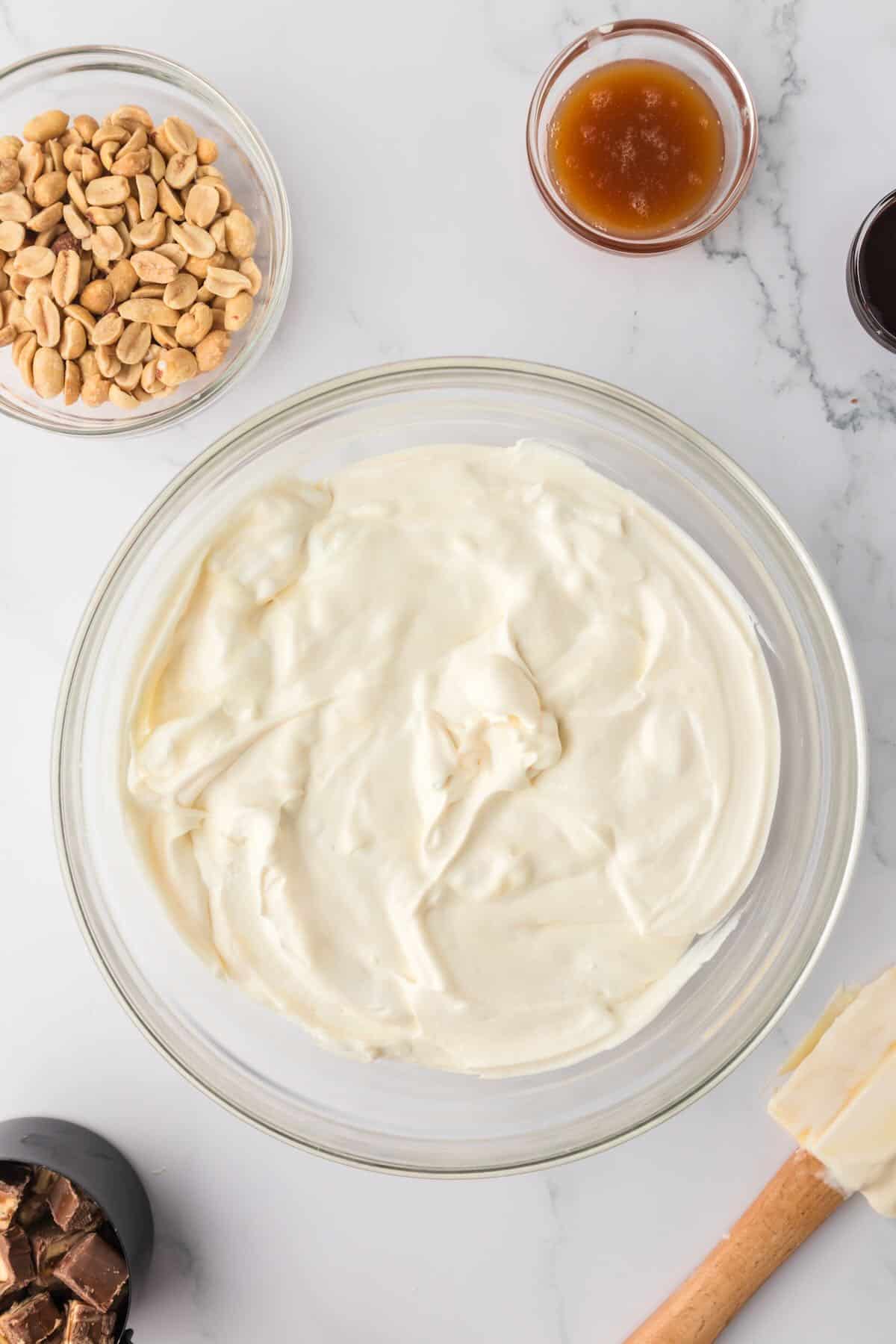 Whipped cream, condensed milk and vanilla combined in a bowl. 