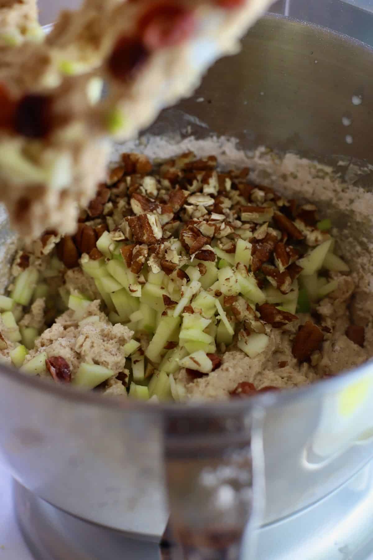 Adding chopped apples and pecans to muffin batter. 