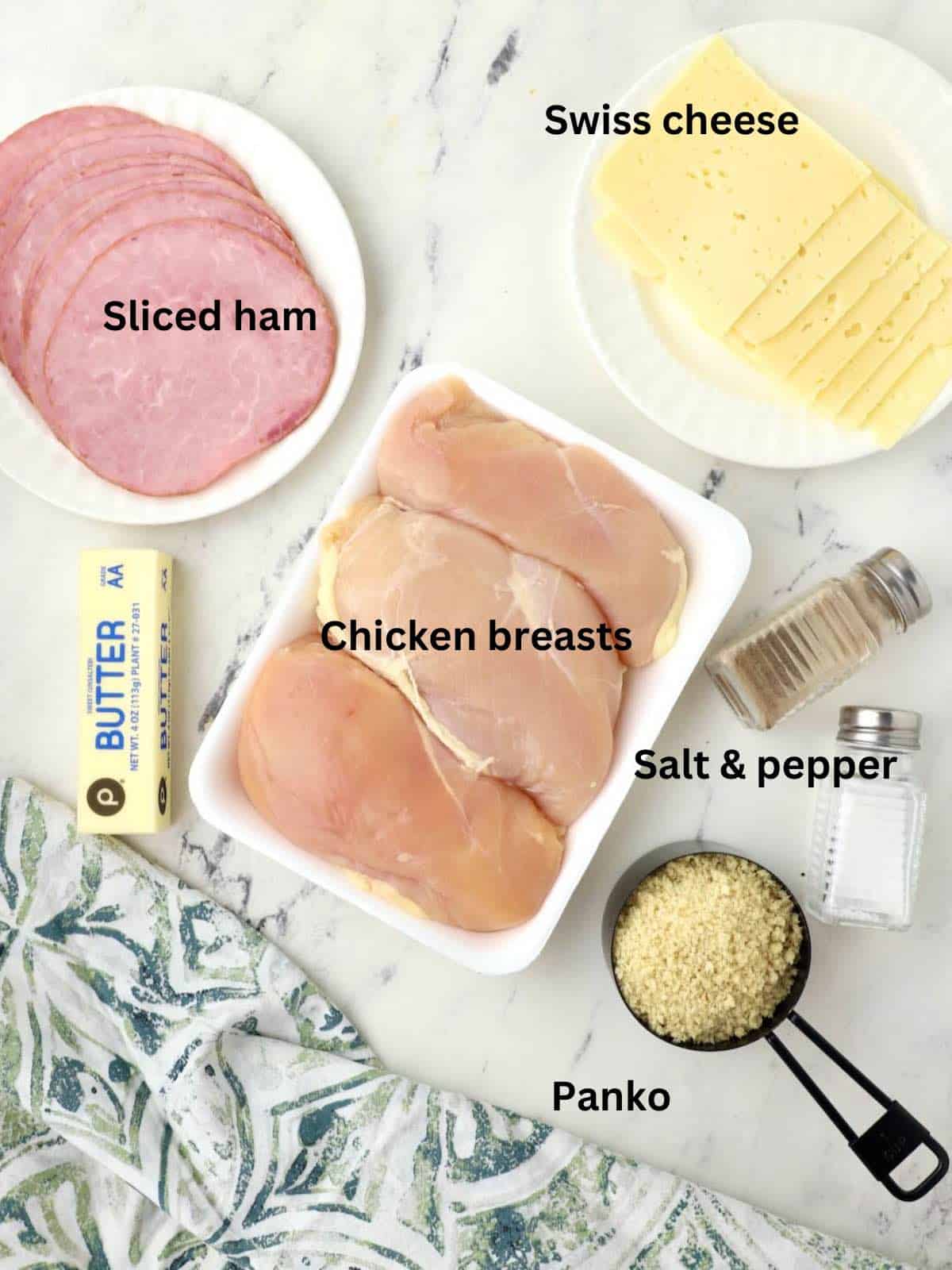 Ingredients for chicken cordon bleu casserole including sliced ham and swiss cheese. 