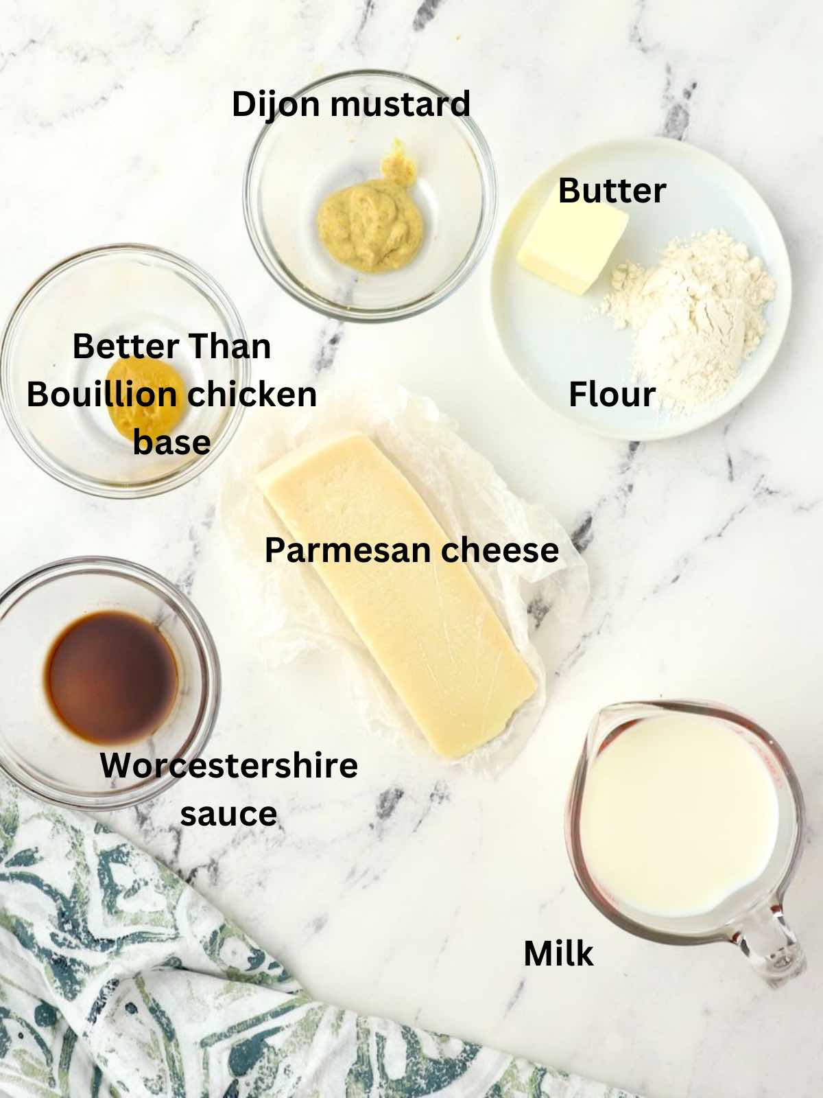 Ingredients for the casserole sauce including parmesan cheese, milk, butter, and flour. 