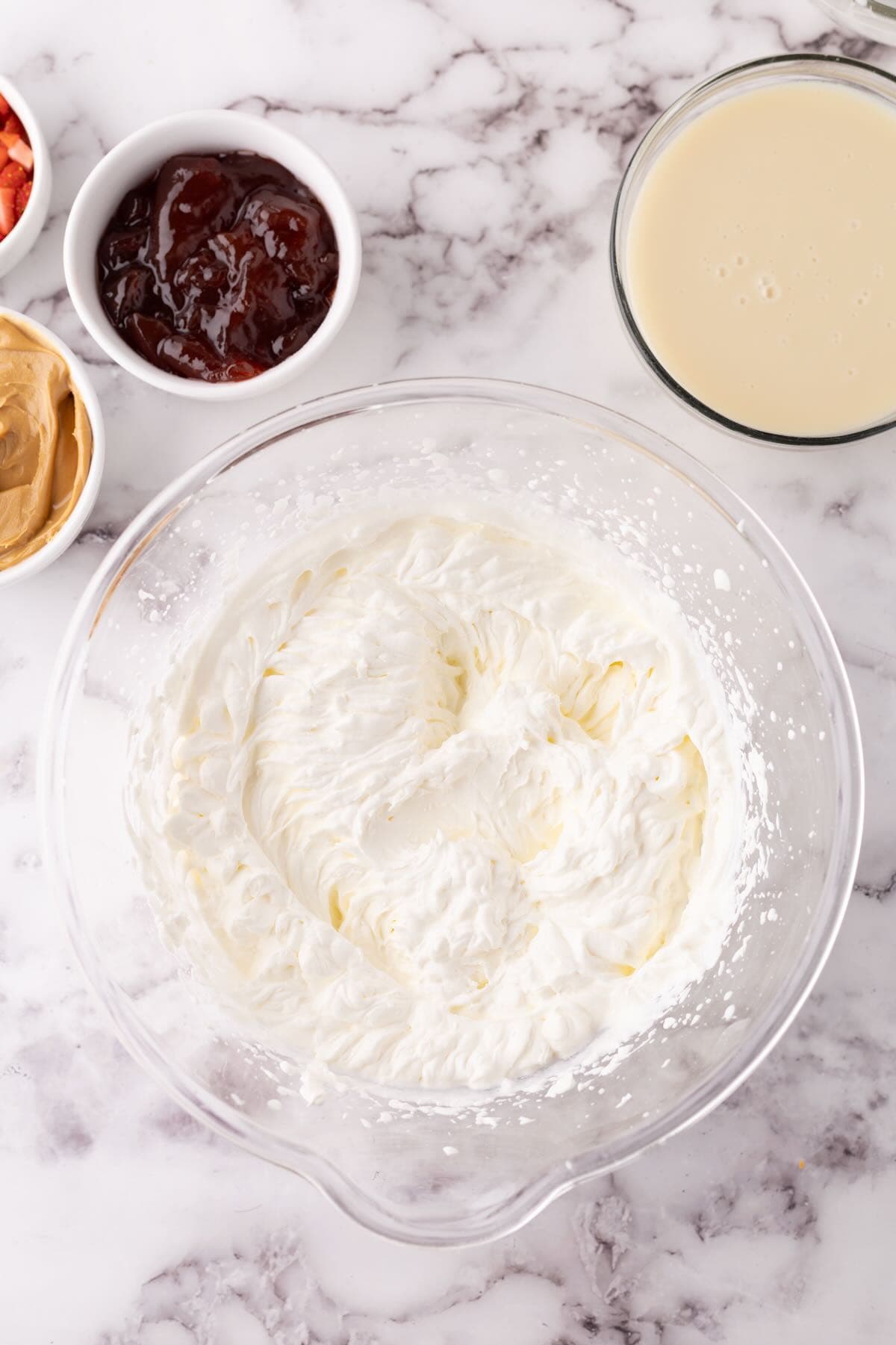 A bowl of whipped cream whipped to the stuff peak stage. 