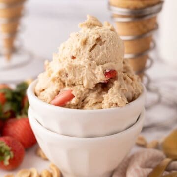 Several scoops of peanut butter and jelly ice cream in white bowls.