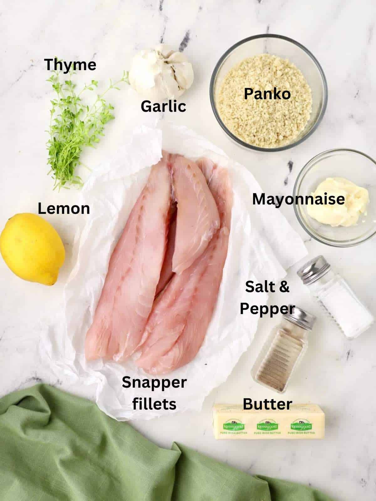 Ingredients for crispy baked snapper fillets including panko, lemon, and fresh thyme. 