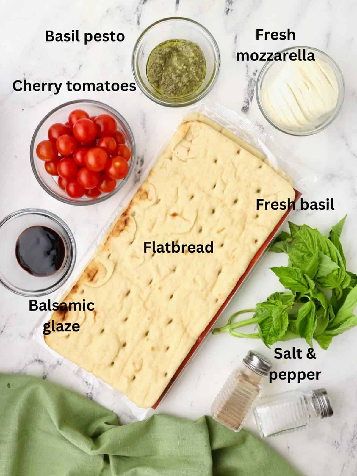 Ingredients for Caprese Flatbread including basil, mozzarella cheese, and tomatoes. 
